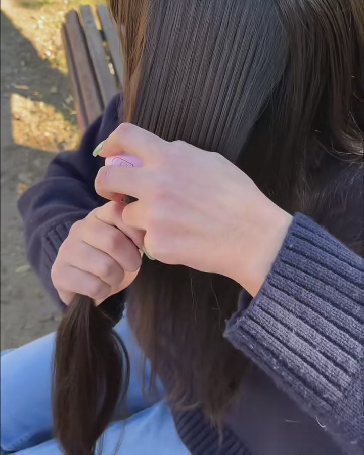 Smoothing a section of hair with The Mini