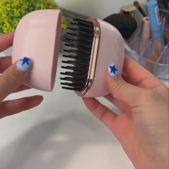 The Mini opened, heat level lights, smoothing a section of hair and closing the lid